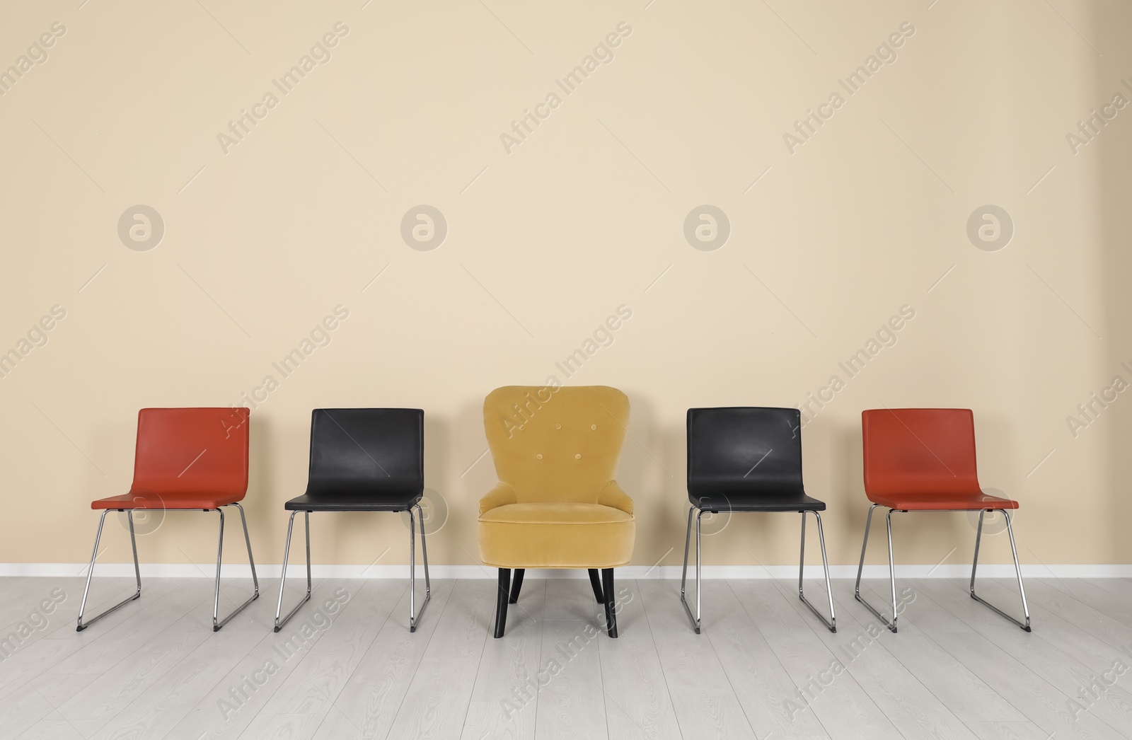 Photo of Comfortable armchair and chairs indoors. Interior decor elements