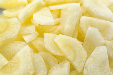 Photo of Pieces of raw white carrot as background, closeup