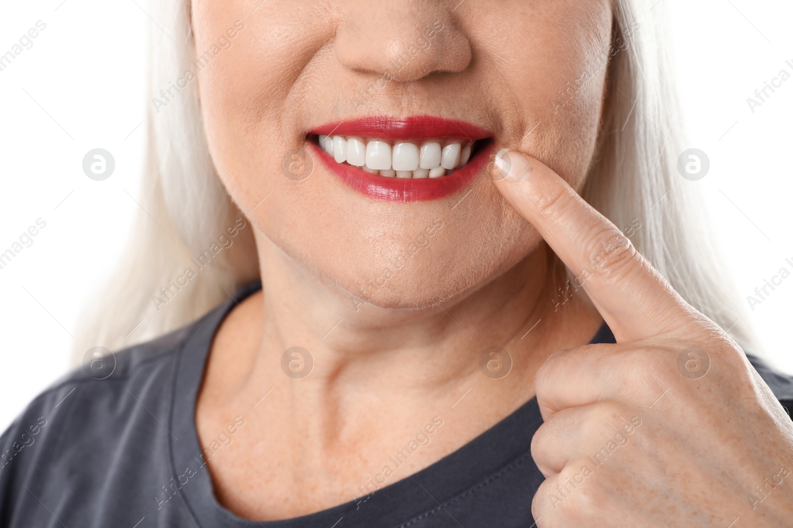 Photo of Smiling woman with perfect teeth on white background, closeup