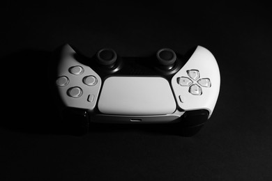 Photo of One wireless game controller on black background