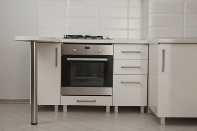 Photo of New gas stove and oven in stylish kitchen