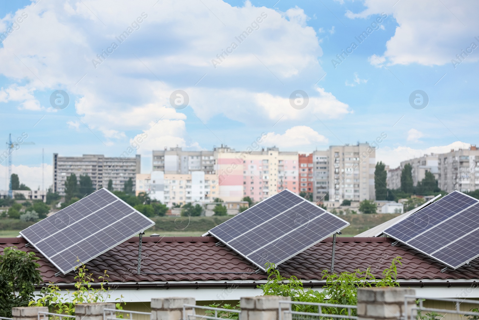 Photo of House with installed solar panels on roof. Alternative energy source