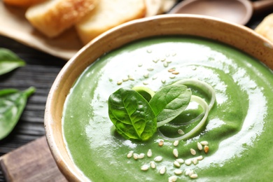 Photo of Fresh vegetable detox soup made of spinach in dish on table, closeup