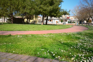 Photo of Beautiful city park in suburban district on sunny day