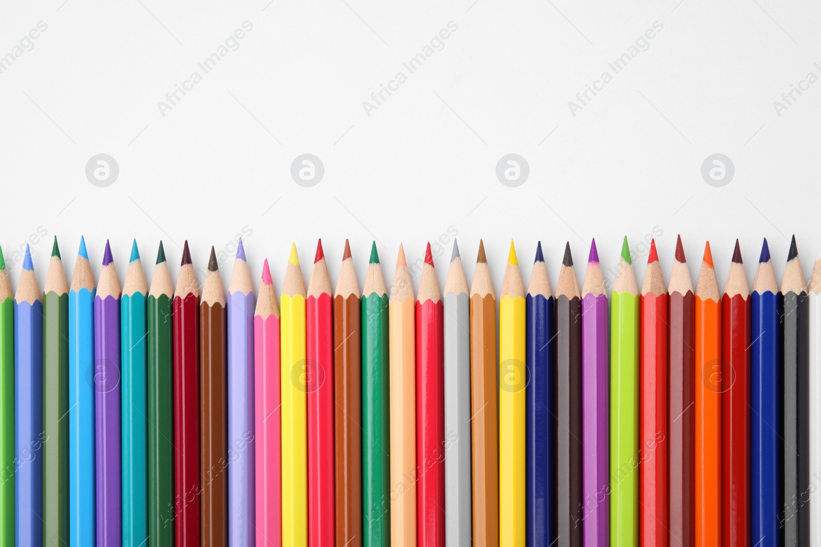 Photo of Colorful wooden pencils on white background, flat lay. Space for text