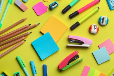 Photo of School stationery on yellow background, flat lay. Back to school