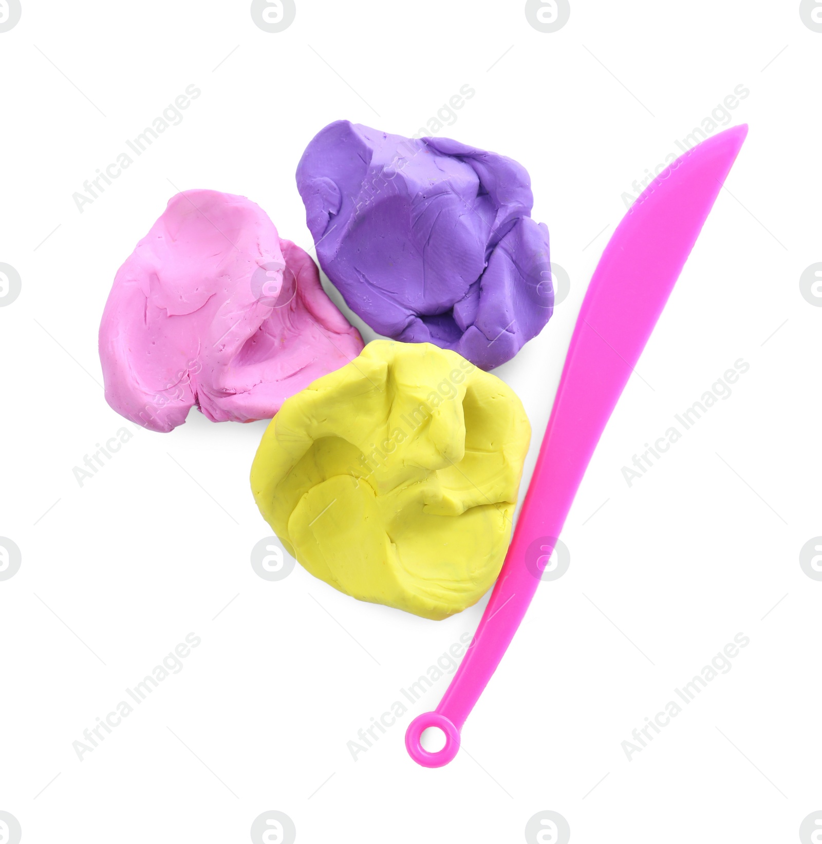 Photo of Colorful plasticine and knife on white background, top view