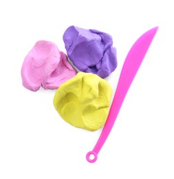 Photo of Colorful plasticine and knife on white background, top view