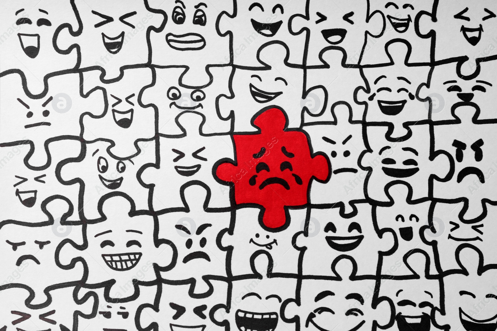 Photo of Drawing of white puzzle pieces and one red with different emotions, closeup. Bullying concept