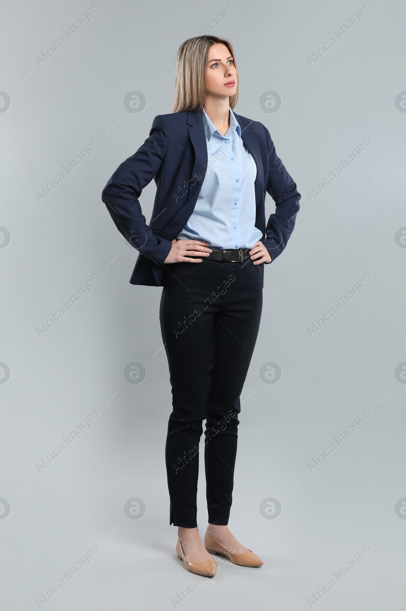 Photo of Full length portrait of young woman on grey background