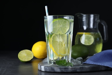 Photo of Delicious lemonade made with soda water and fresh ingredients on grey table