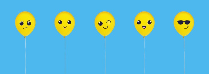 Image of Set of balloons with different emoticons on light blue background. Banner design