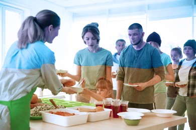 Image of Double exposure of volunteers serving food to refugees and Ukrainian flag. Help during war