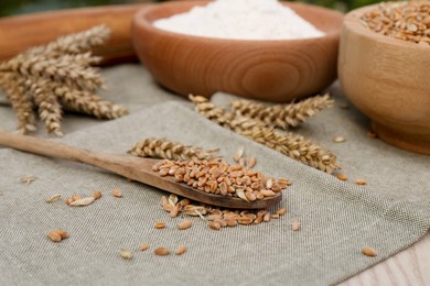 Wheat grains, flour and spikelets on cloth
