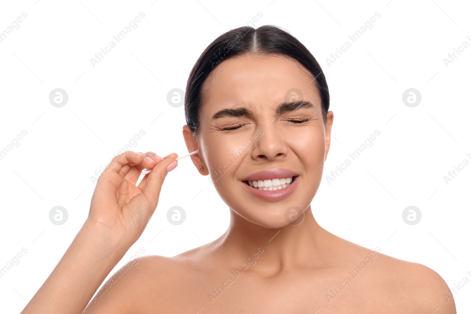 Photo of Young woman cleaning ear with cotton swab on white background