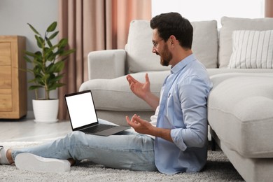 Man having video chat via laptop at home