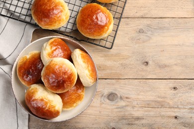 Tasty scones prepared on soda water on wooden table, flat lay. Space for text