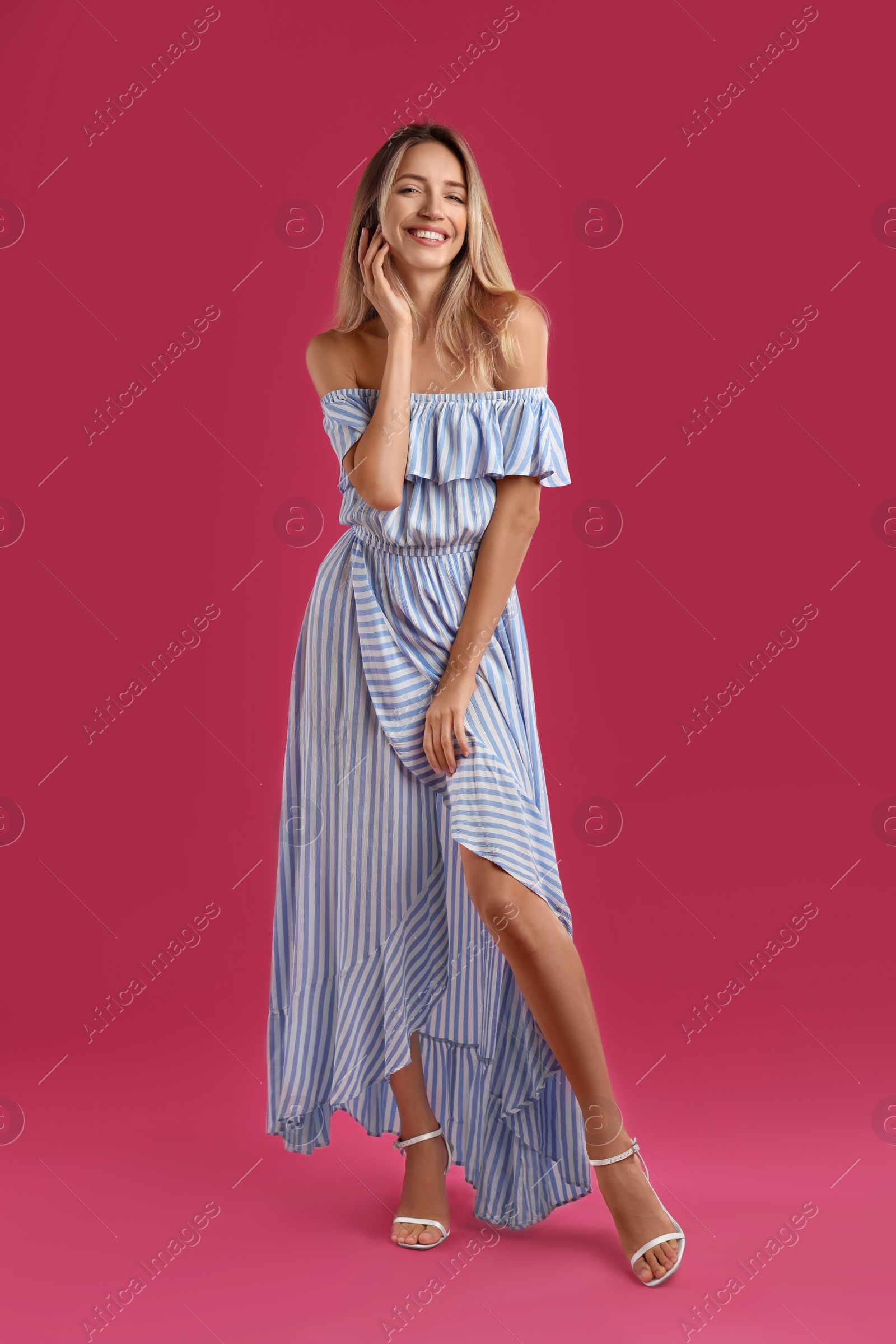 Photo of Young woman wearing stylish dress on pink background