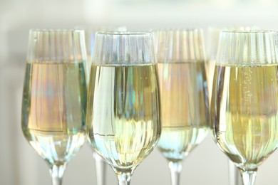 Glasses of champagne on blurred background, closeup view