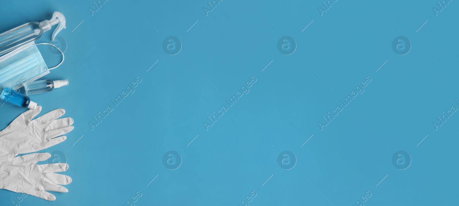 Image of Medical gloves, mask and hand sanitizers on blue background, flat lay. Banner design with space for text 