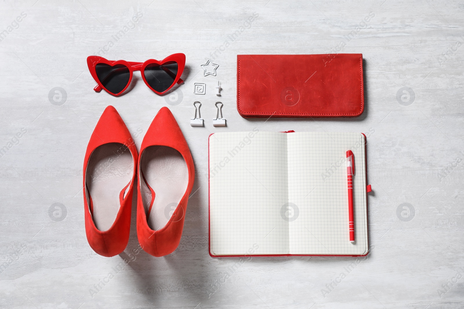 Photo of Flat lay composition with women's accessories and notebook on light table. Space for text