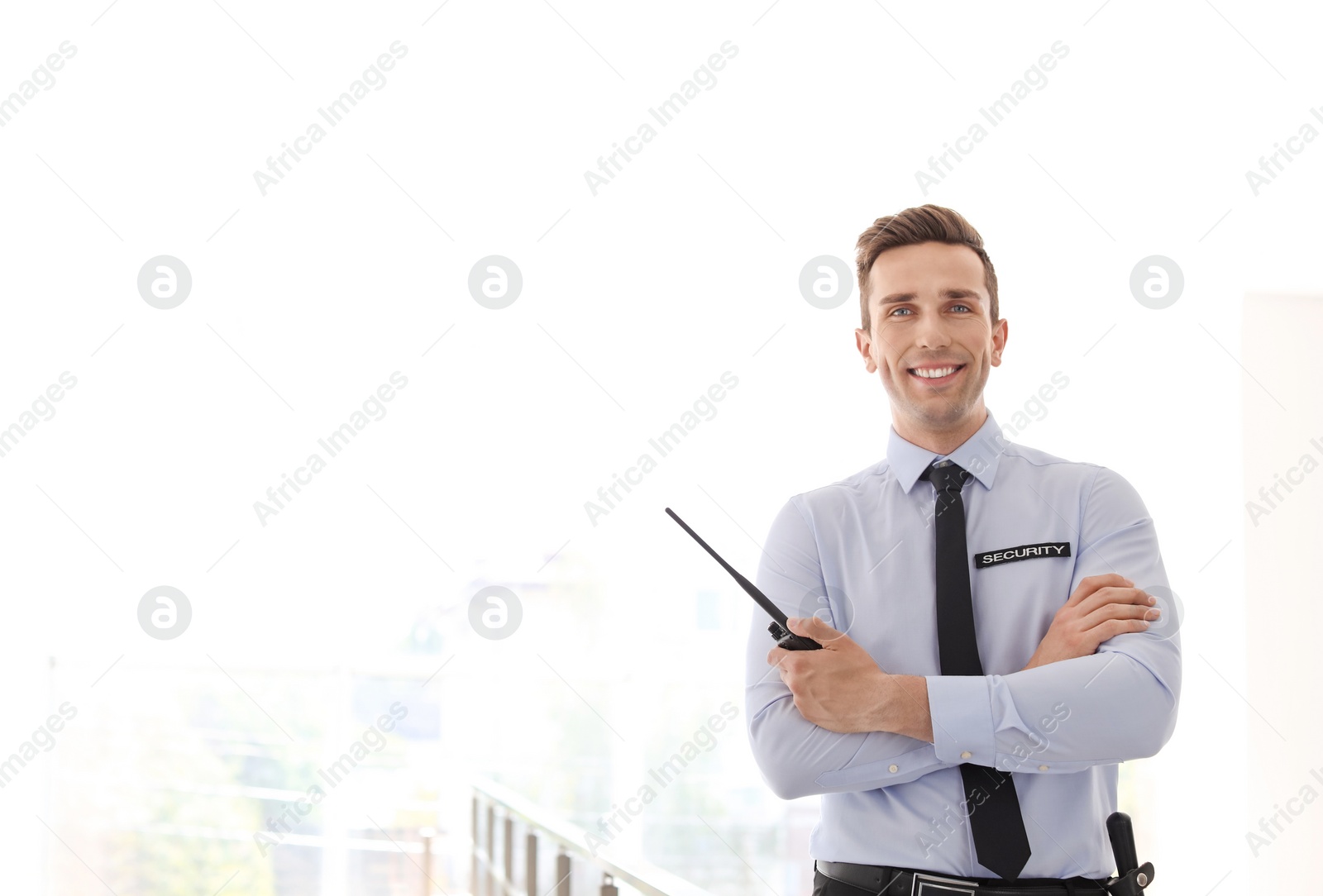 Photo of Male security guard with portable radio transmitter indoors