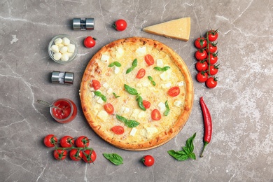 Photo of Flat lay composition with delicious pizza and ingredients on table