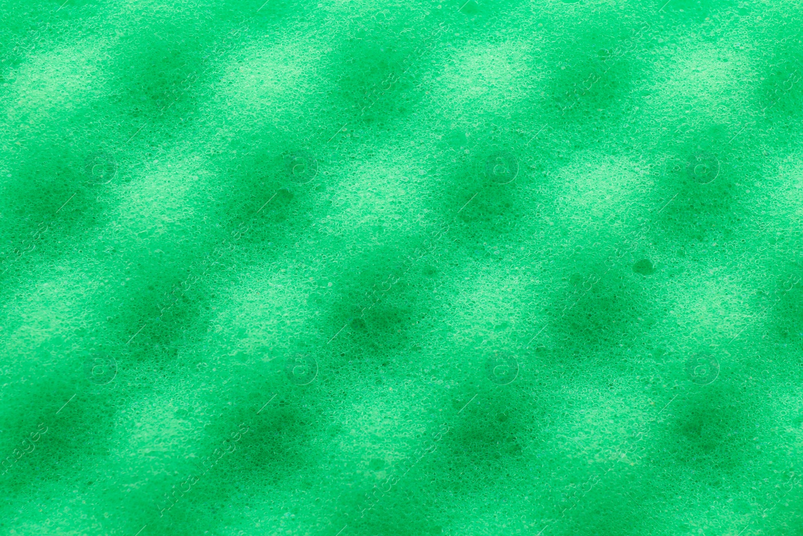 Photo of Green cleaning sponge as background, top view