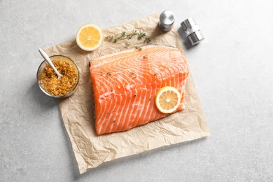 Photo of Raw salmon fillet and ingredients for marinade on table, top view