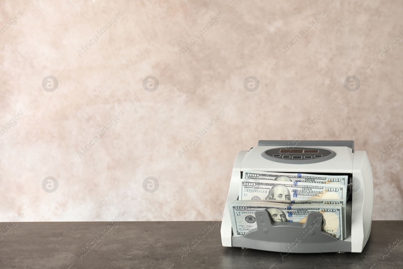 Photo of Modern bill counter with money on table. Space for text