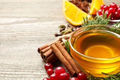 Composition with mulled wine ingredients on wooden table, closeup. Space for text