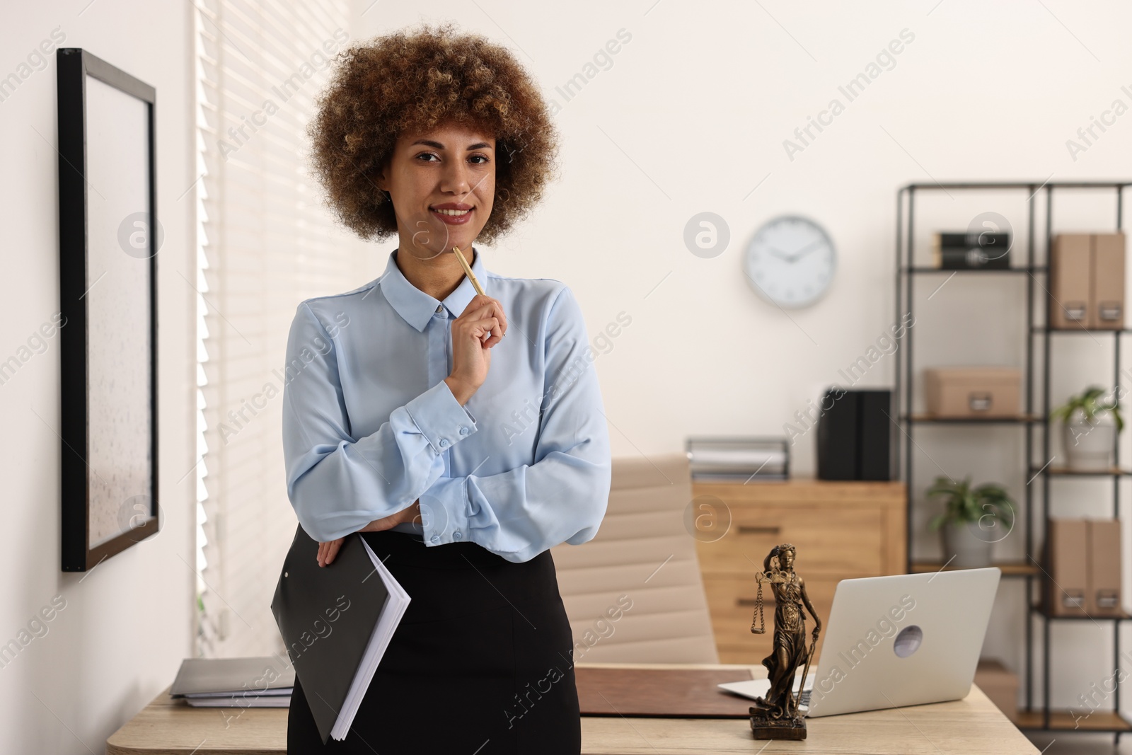 Photo of Happy notary with clipboard and pen in office