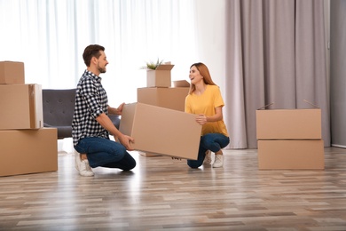 Photo of Couple with moving box in their new house