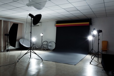 Interior of modern photo studio with professional lighting equipment