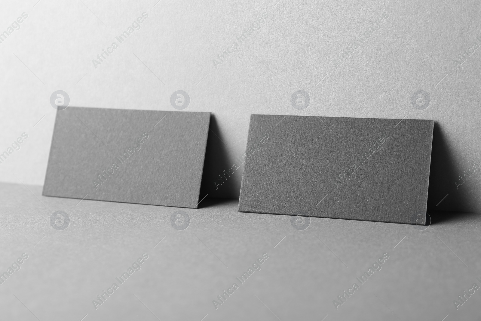 Photo of Blank black business cards on grey background. Mockup for design