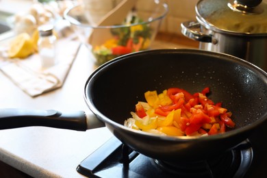 Cooking fresh vegetables in frying pan on stove, closeup