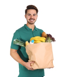 Photo of Young man holding paper bag with products on white background. Food delivery service