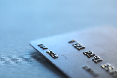 One credit card on gray background, macro view