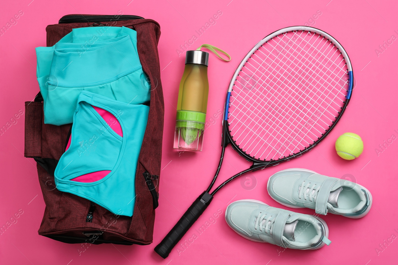 Photo of Gym bag and sports equipment on pink background, flat lay
