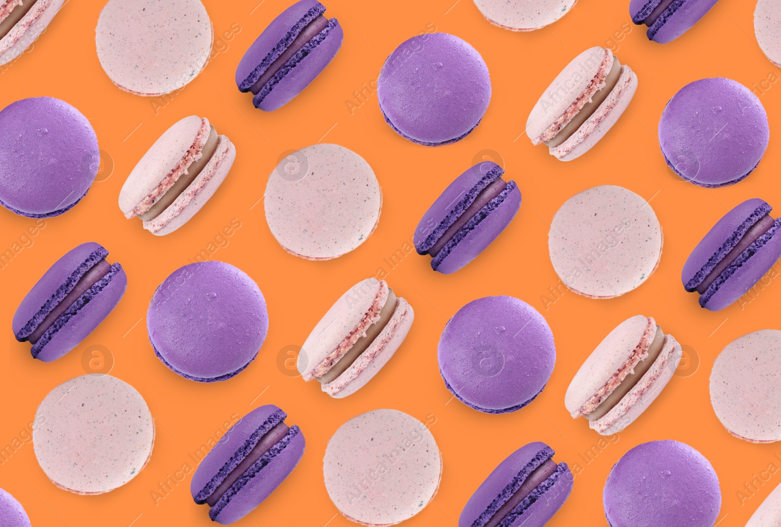 Image of Delicious macarons on orange background, flat lay 