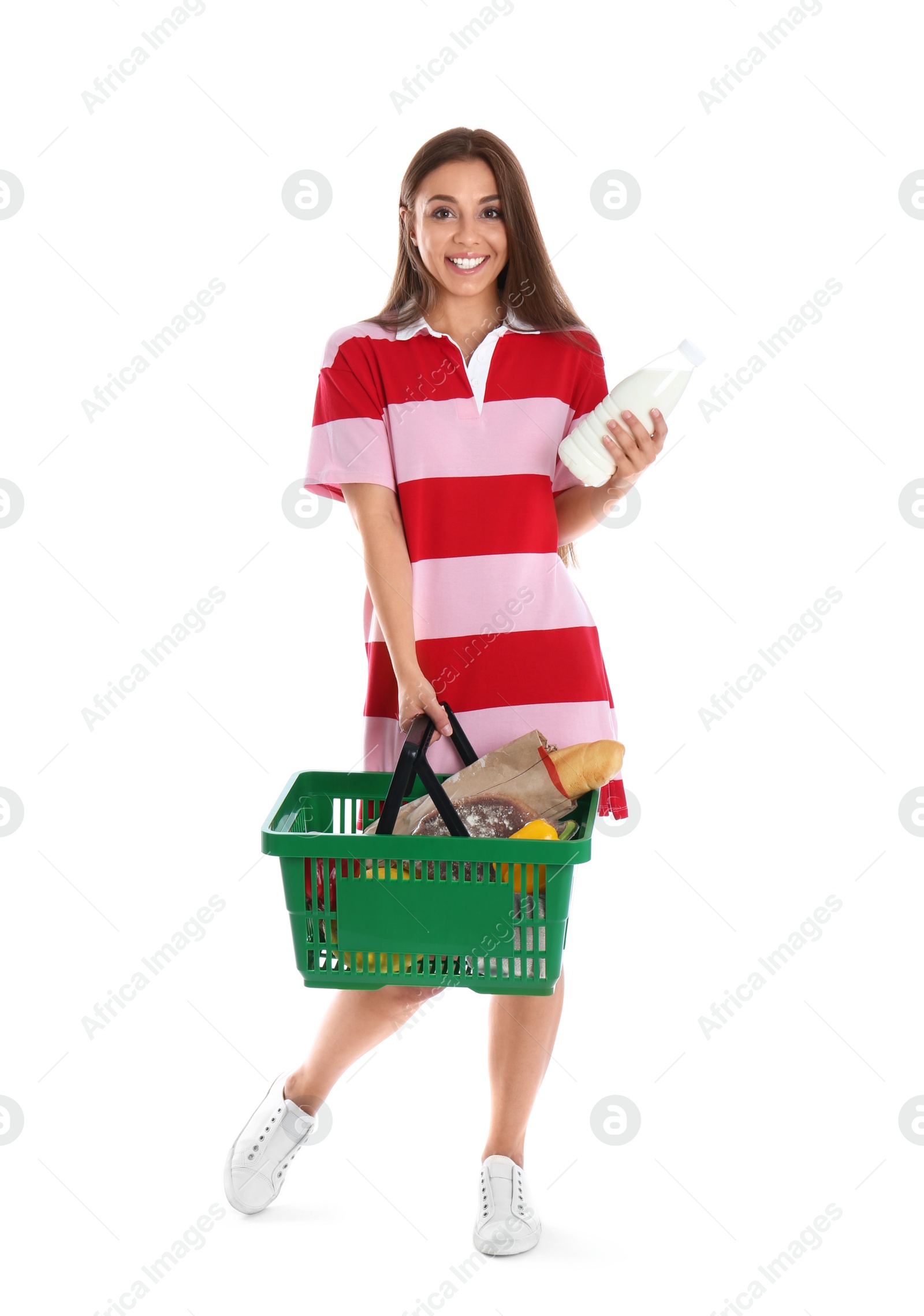 Photo of Young woman with bottle of milk and shopping basket isolated on white