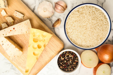 Photo of Flat lay composition with different ingredients on marble table. Risotto recipe