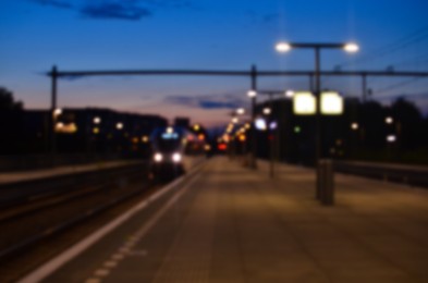 Blurred view of railway platform at night