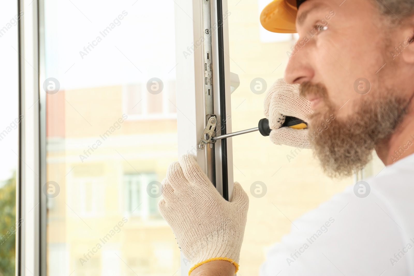 Photo of Construction worker installing new window in house