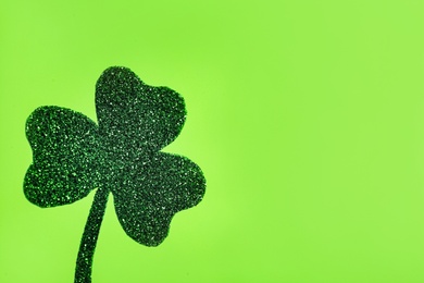 Photo of Decorative clover leaf on light green background, space for text. Saint Patrick's Day celebration