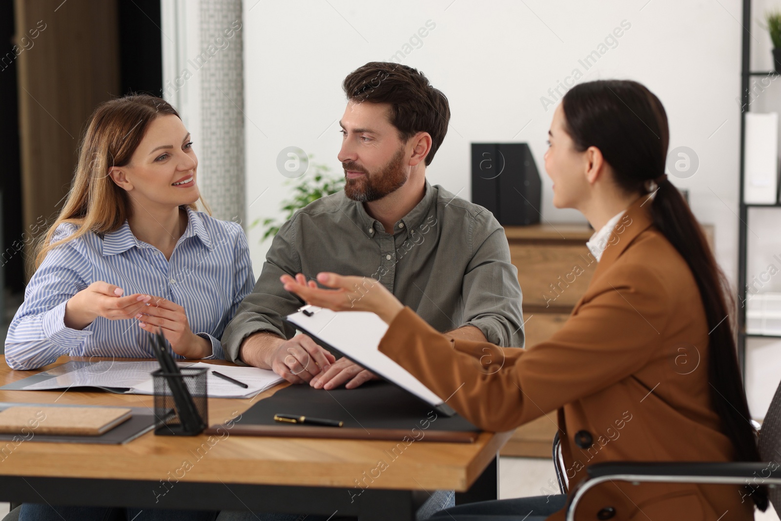 Photo of Couple having meeting with lawyer in office