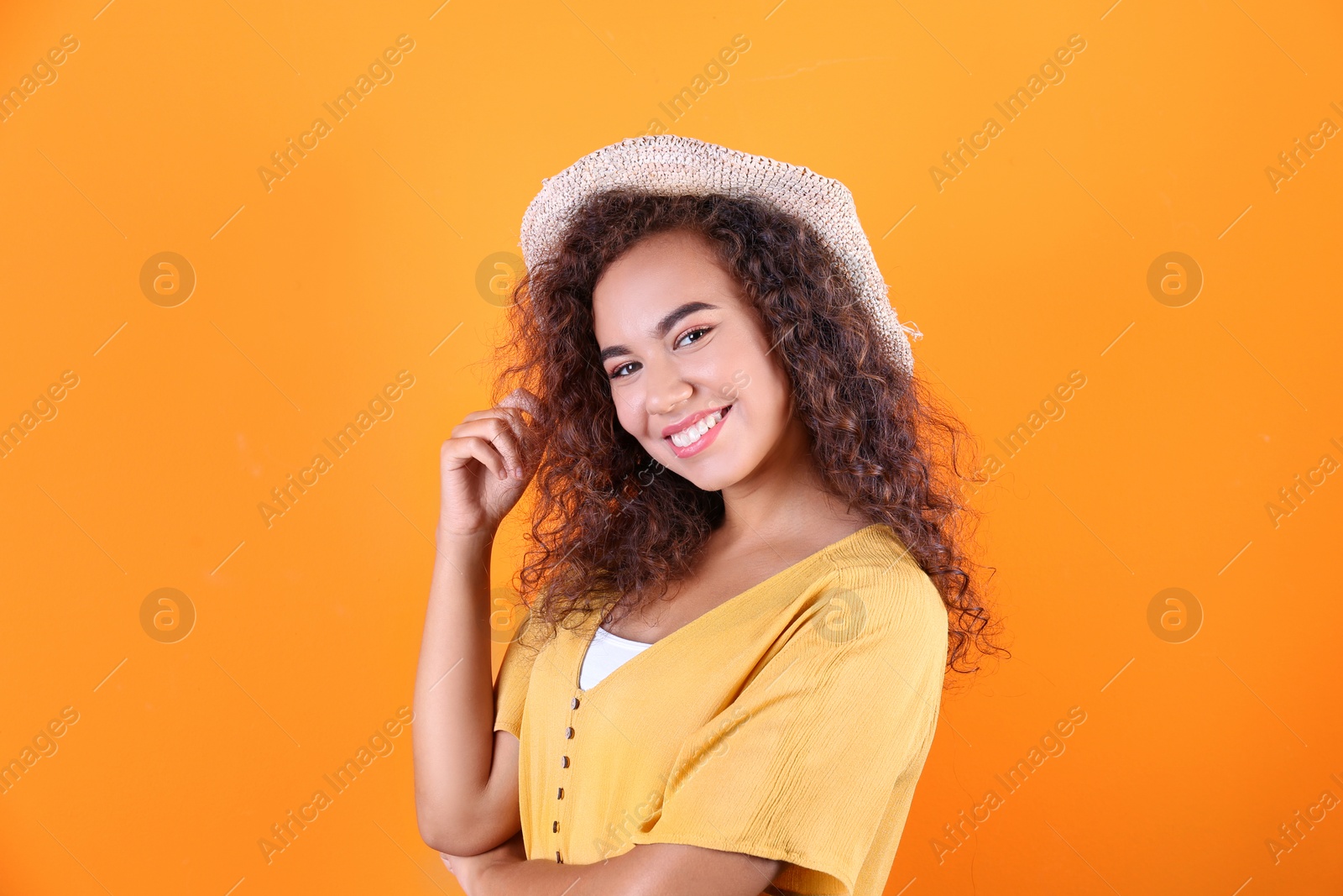 Photo of Portrait of laughing African-American woman on color background