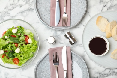 Vegetable salad and balsamic vinegar served on marble table, top view