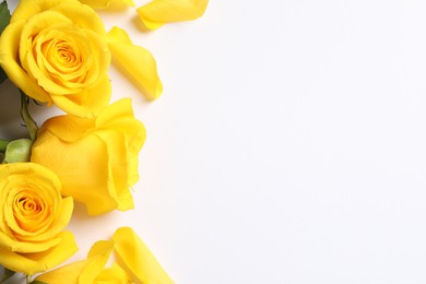 Beautiful yellow roses on white background, flat lay. Space for text