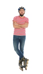 Photo of Full length portrait of young man with inline roller skates on white background
